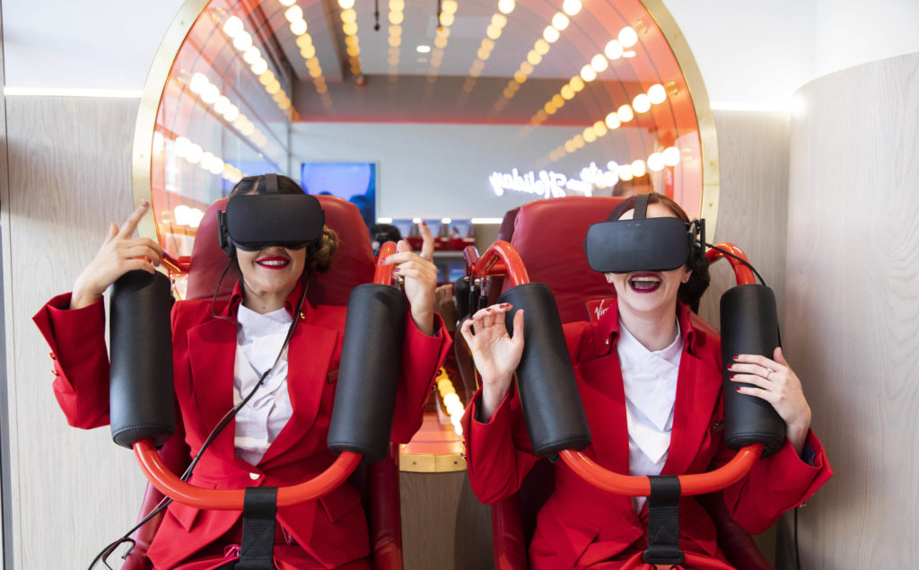 Staff members trying out the virtual rollercoaster at the opening of new Virgin Holidays flagship v-room store