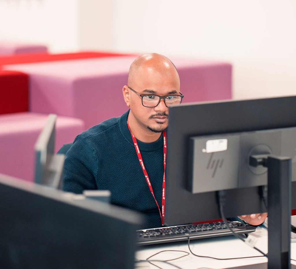 Virgin Atlantic employee staring at a monitor